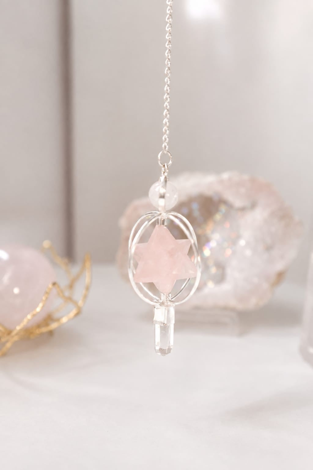 Péndulo con estrella Merkaba de cuarzo rosa y punta de cuarzo transparente